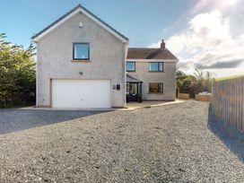 A house with a garage and driveway at Low Greenlands House Tewitfield