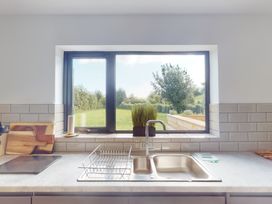 A kitchen with a sink and window at Low Greenlands House in Tewitfield