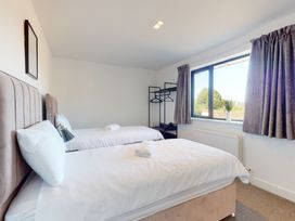 A bedroom with two beds and a window at Low Greenlands House Tewitfield