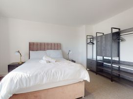 A bedroom with a bed and wardrobe at Low Greenlands House Tewitfield