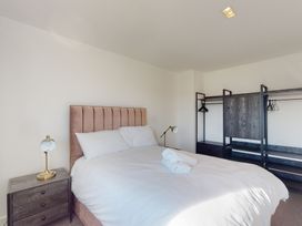 A bedroom with a bed and a wardrobe at Low Greenlands House in Tewitfield