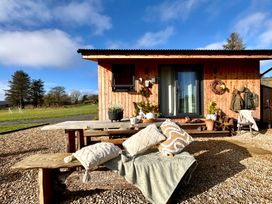 An outdoor seating area with a table and chairs at Harriet in Llangurig