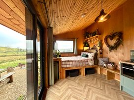 A bedroom with a bed and shelf at Harriet in Llangurig