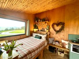 A bedroom with a bed and shelf at Harriet in Llangurig