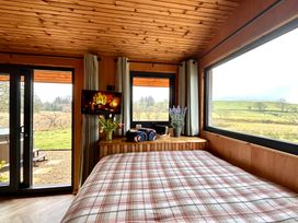 A bedroom with a bed and television at Harriet in Llangurig