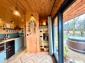 A kitchen with a bunk bed and hot tub at Harriet in Llangurig