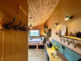 A bedroom with a bed and shelf at Harriet in Llangurig
