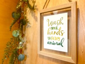 A framed sign with the text 'Wash your hands ya filthy animal' at Harriet in Llangurig