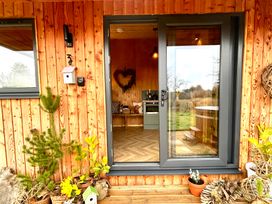 An entryway with an open door and kitchen visible at Harriet Llangurig