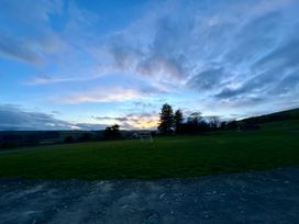 A field with trees and soccer goals at Harriet in Llangurig