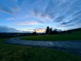 A field with goalposts and trees at Harriet in Llangurig