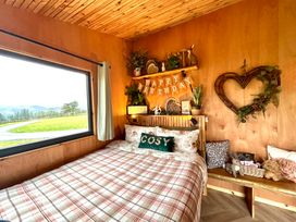 A bedroom with a bed and decorative elements at Harriet in Llangurig