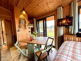 A dining room with a table and chairs at Harriet in Llangurig