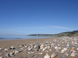 A beach with rocks and water at Garden Studio at Stanley House Charmouth