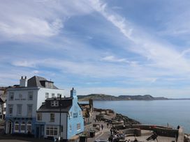 A coastal view with a building near the sea at Garden Studio at Stanley House Charmouth