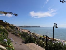 A view of the beach and sea from a pathway at Garden Studio at Stanley House Charmouth