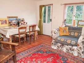 A dining room with a table and chairs at The Hare & the Bumblebee Cottage