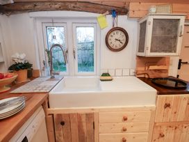 A kitchen with a sink and window at The Hare & the Bumblebee Cottage