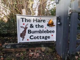 A sign with a rabbit and bee at The Hare & the Bumblebee Cottage