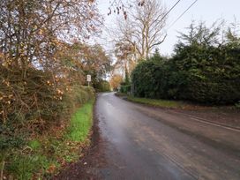A road lined with trees and bushes at The Hare & the Bumblebee Cottage