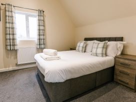 A bedroom with a double bed and two pillows at Aspen Lodge in Brigg