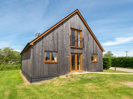 A house with windows and a balcony at Aspen Lodge Near Brigg