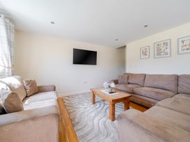 A living room with a television and a coffee table at Aspen Lodge Near Brigg