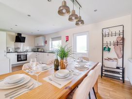 A dining room with a wooden table and chairs at Aspen Lodge near Brigg