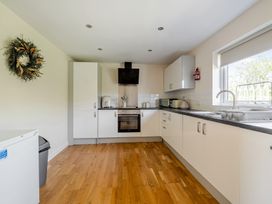 A kitchen with cabinets and appliances at Aspen Lodge Near Brigg