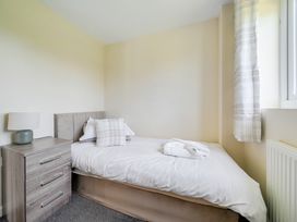 A bedroom with a bed and bedside table at Aspen Lodge Near Brigg
