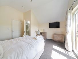 A bedroom with a bed and a dresser at Aspen Lodge Near Brigg