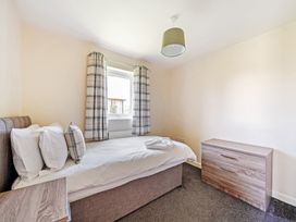 A bedroom with a bed and window at Sage Lodge Near Brigg