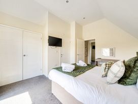 A bedroom with a bed and television at Sage Lodge Near Brigg