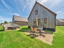 A house with a patio and hot tub in the outdoor area at Sage Lodge near Brigg
