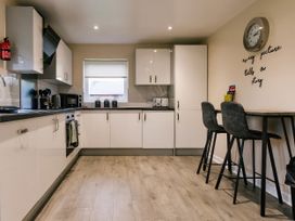 A kitchen with appliances and seating at Raven Lodge in Brigg