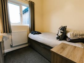 A bedroom with a bed and a radiator at Raven Lodge in Brigg