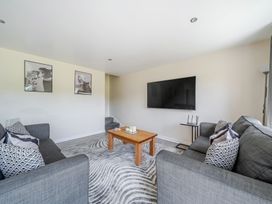 A living room with a television and coffee table at Raven Lodge Near Brigg