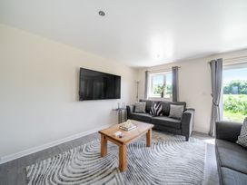 A living room with a sofa and coffee table at Raven Lodge Near Brigg