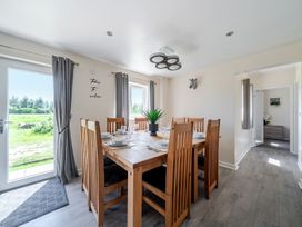 A dining room with a table set for meals at Raven Lodge near Brigg