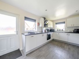A kitchen with cabinets and appliances at Raven Lodge Near Brigg