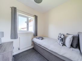 A bedroom with a bed and window at Raven Lodge Near Brigg