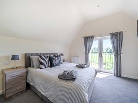 A bedroom with a bed and nightstand at Raven Lodge near Brigg