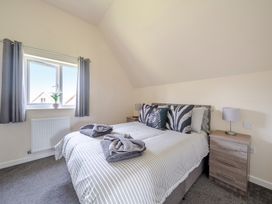 A bedroom with a bed and bedside table at Raven Lodge Near Brigg