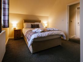A bedroom with a bed and bedside lamps at Paddington Lodge in Brigg