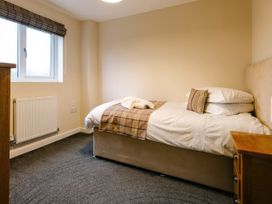 A bedroom with a bed and nightstand at Paddington Lodge in Brigg