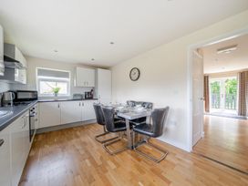 A kitchen with a dining table and chairs at Paddington Lodge near Brigg