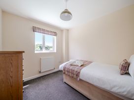 A bedroom with a bed and window at Paddington Lodge Near Brigg