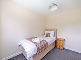 A bedroom with a bed and nightstand at Paddington Lodge near Brigg