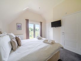 A bedroom with a bed and television at Paddington Lodge near Brigg