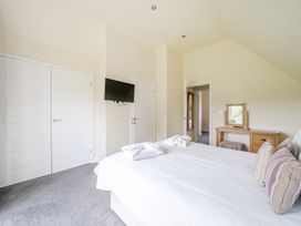A bedroom with a bed and dresser at Paddington Lodge near Brigg